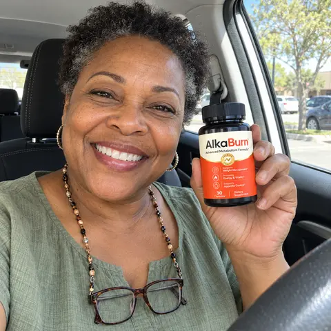 A woman in her car holding a bottle of AlkaBurn